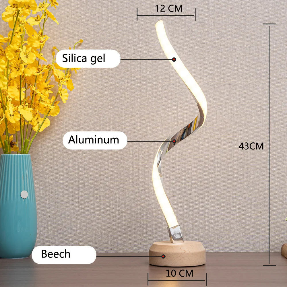 LED spiral table lamp with wooden curved base and USB cable, glowing warm white light