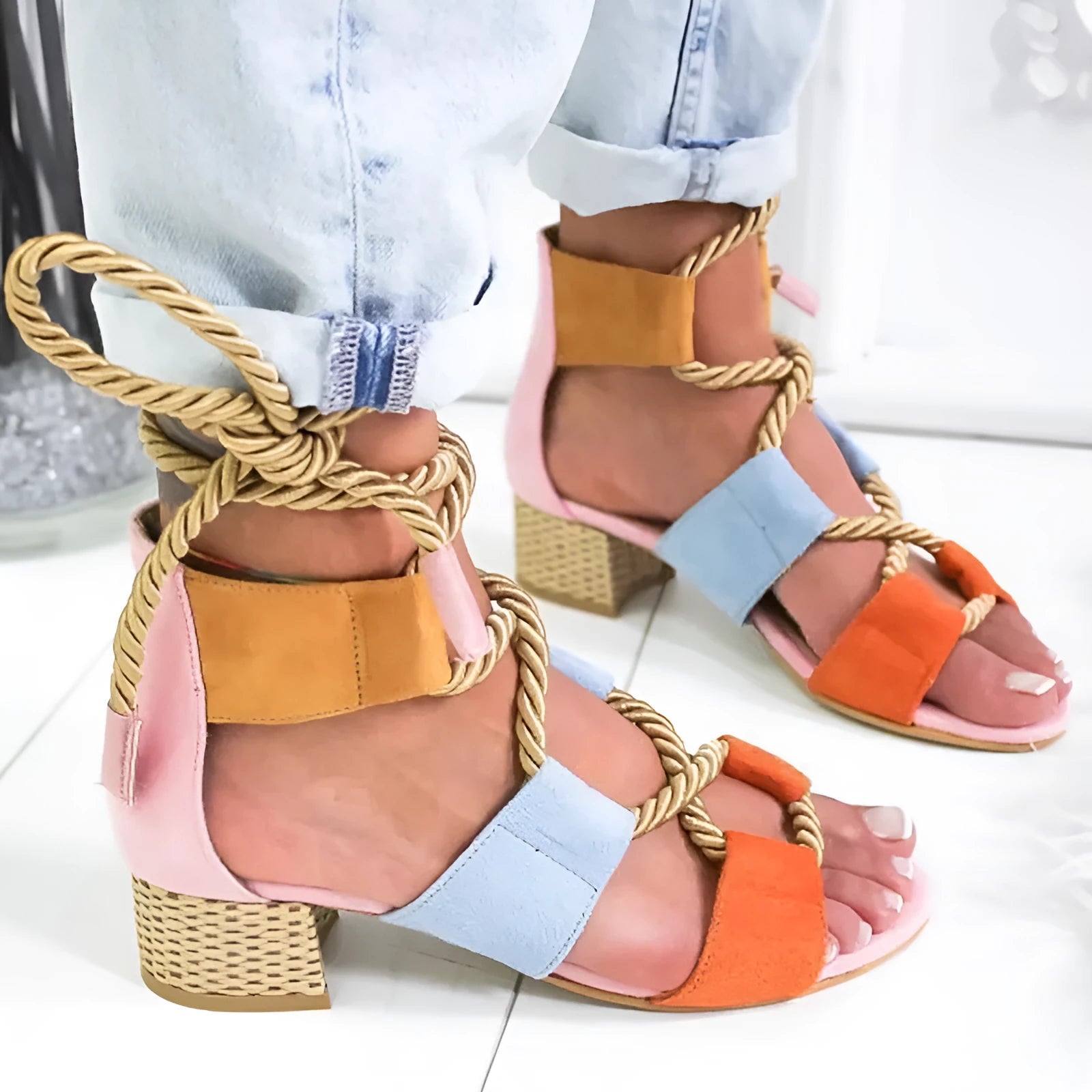Women's beige suede sandals with thick heel, front strap, and ankle strap on a white background.