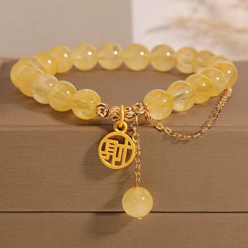Natural citrine stone bracelet with an electroplated Chinese character tassel charm.