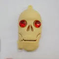 Skull-shaped USB flash drive on a small chain with PVC shell and USB 3.0 connector.