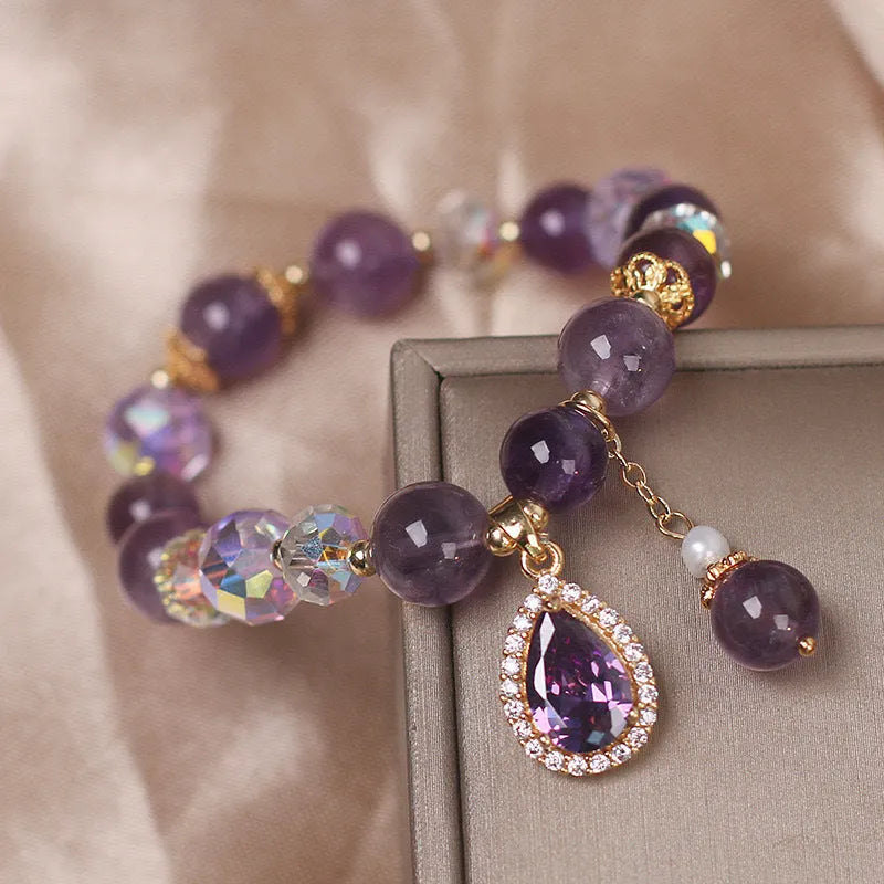 Close-up of a women's purple amethyst crystal bracelet with micro inlay detailing.