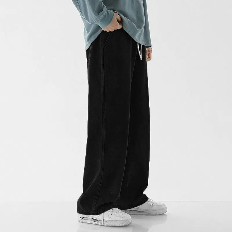 Mens fashion casual loose straight cotton denim jeans in retro light blue colour, full-length view