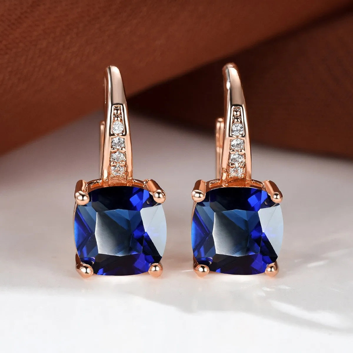 Square geometric ear hook studs with a round zircon stone, shown in a gold electroplated finish.
