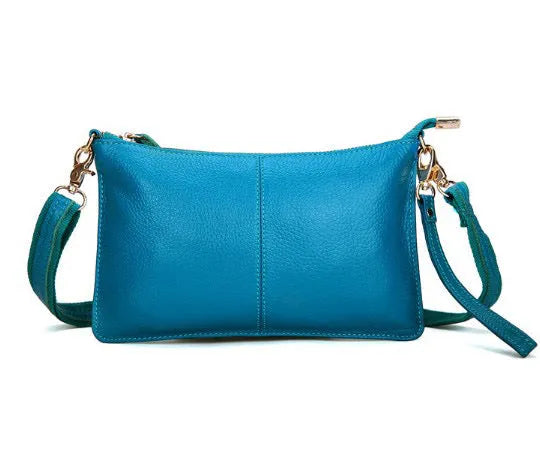 Structured cowhide lady slant bag in apricot colour with hand strap and shoulder strap, showing slim profile.