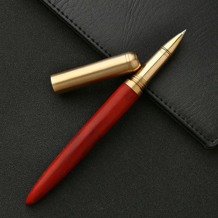Brass and sandalwood solid wood signature pen with wooden barrel and brass fittings on a desk