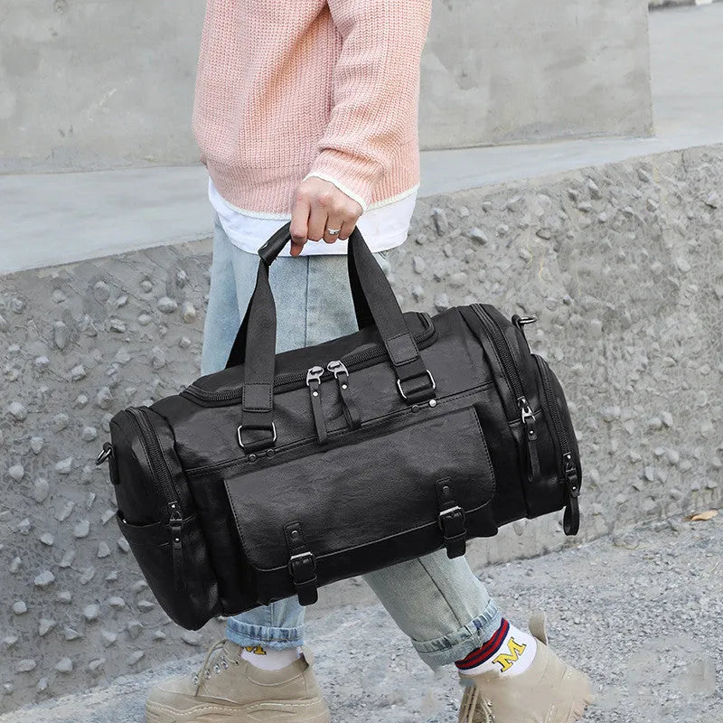 Large black travel bag with dual shoulder straps and a separate internal shoe compartment.