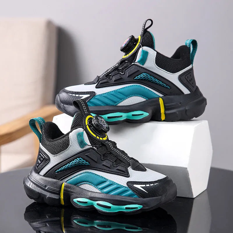 Children's waterproof leather basketball shoes with rotating buckle, black and grey colour, on natural lawn