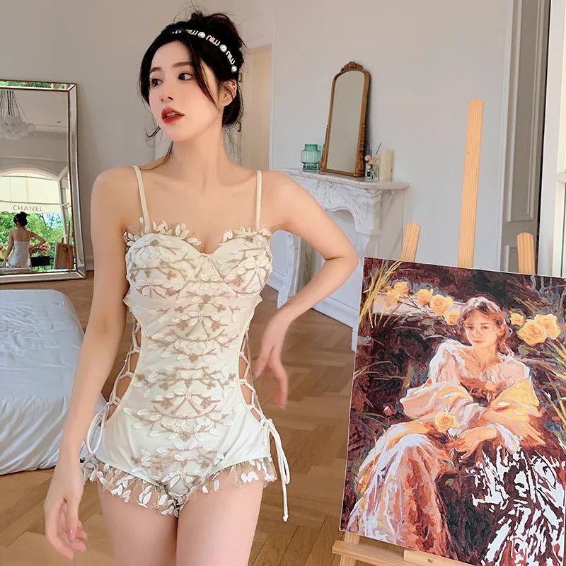 White women's one-piece swimsuit with hollow waist and backless design showing thin straps