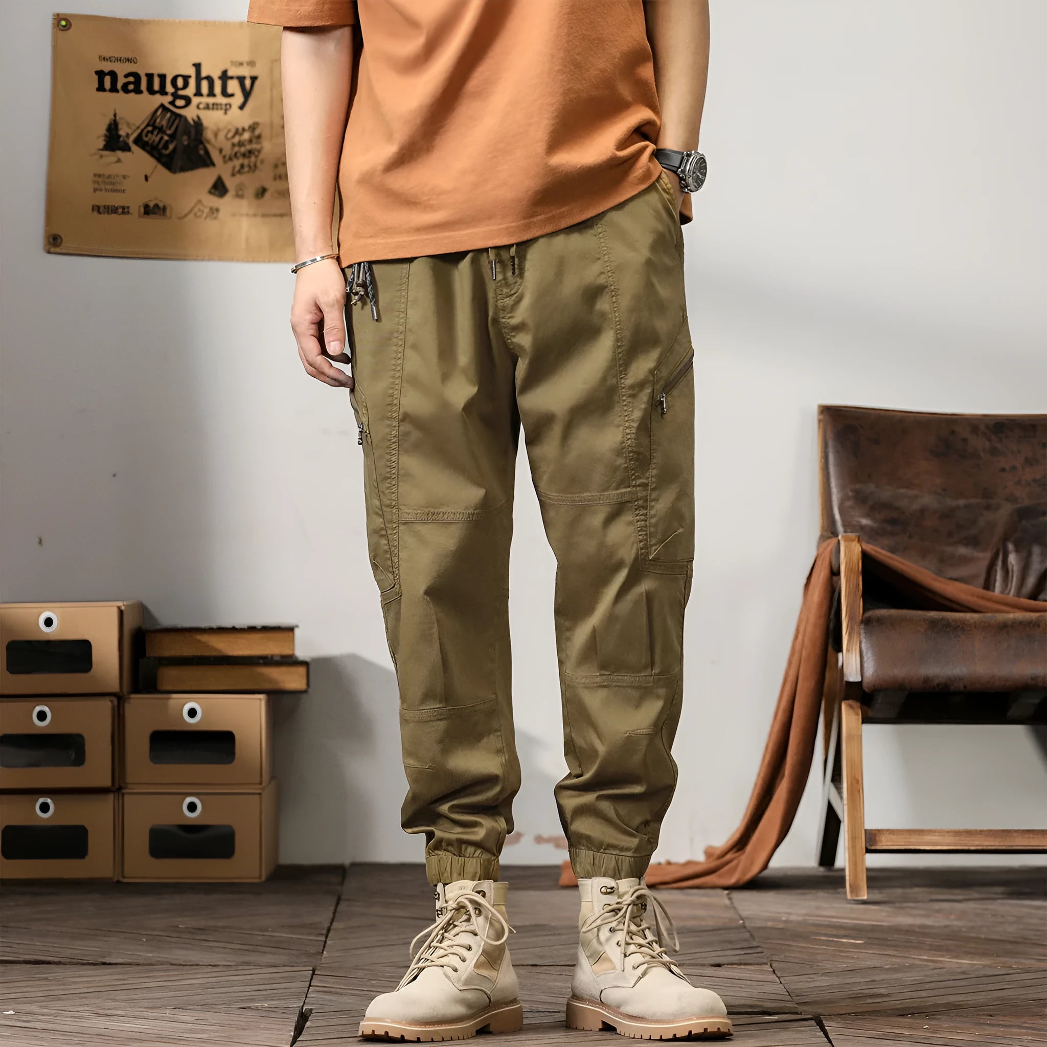 Men's loose fit cotton trousers with tapered ankle banded legs in khaki colour.