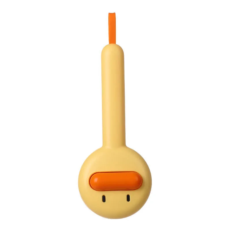 Small yellow duck-shaped comb for pet grooming with needle points and floating hair removal device
