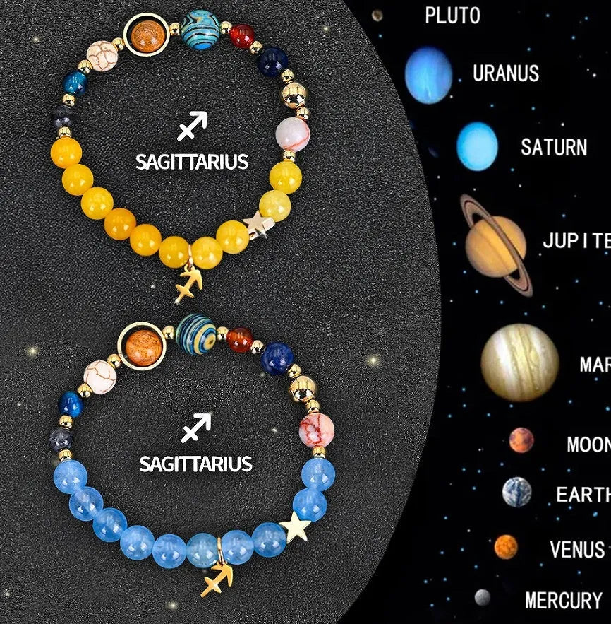 Two natural stone beaded bracelets with zodiac sign charms on a wooden surface