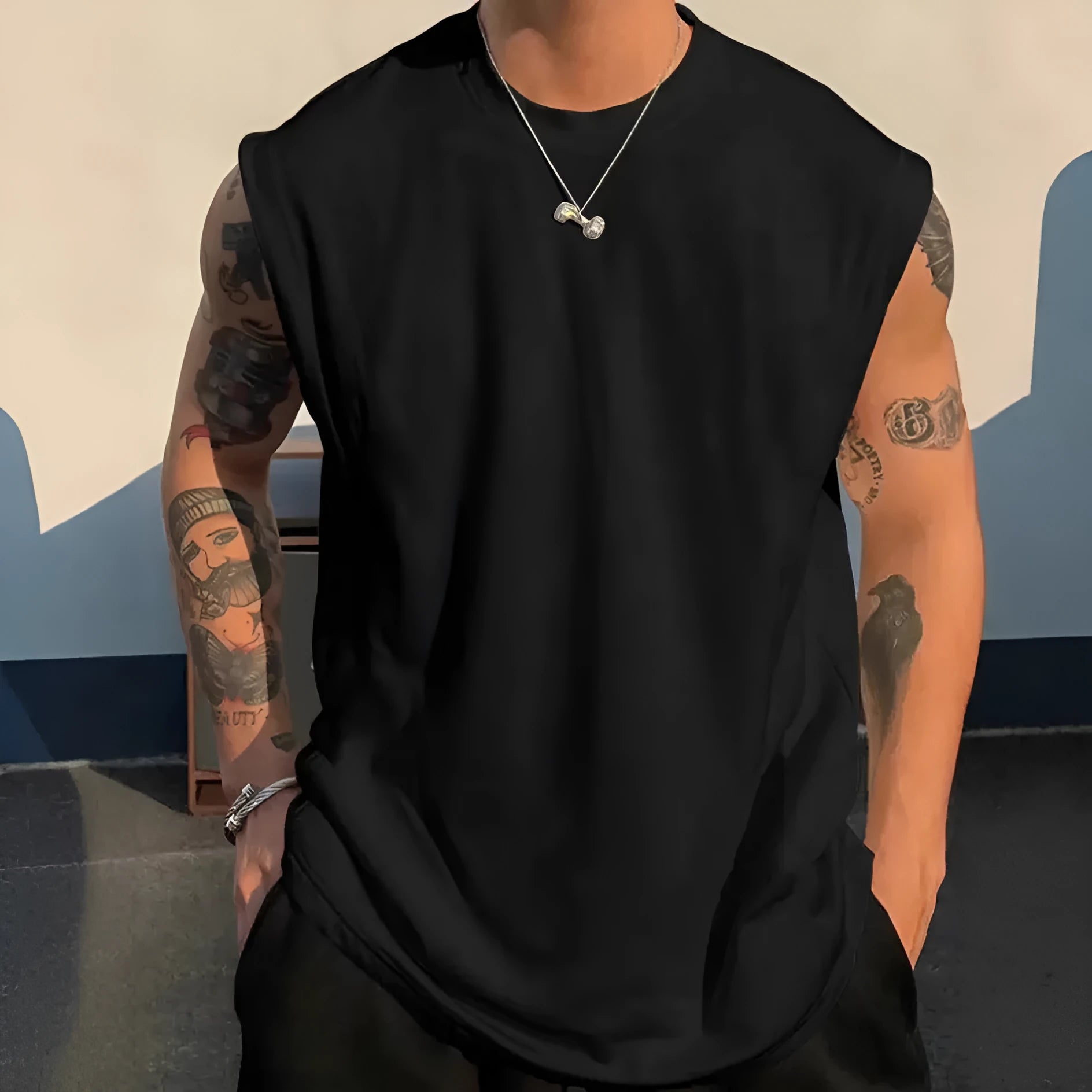 Men's loose fit sleeveless cotton tank top in solid colour on a hanger