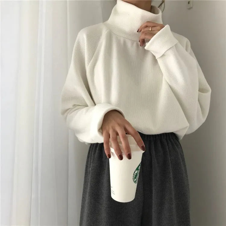 Women's loose-fitting long sleeve top with a half-high collar in a solid colour.