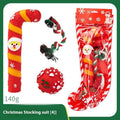 Christmas-themed vinyl dog toys including barbell, ball, rope, and Santa designs in gift packaging