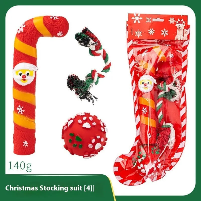 Christmas-themed vinyl dog toys including barbell, ball, rope, and Santa designs in gift packaging