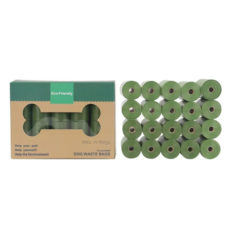Roll of green EPI degradable dog poo bags next to a white plastic dispenser on a grass background.