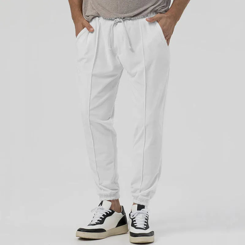 Men's loose tapered casual track sweatpants in cotton blend fabric showing straight-leg design