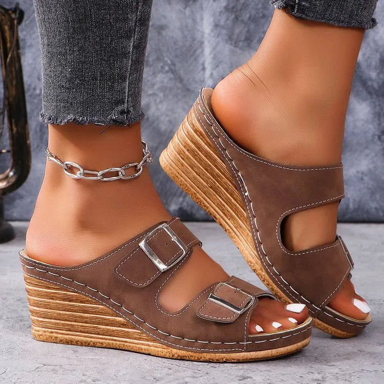 Women's creamy-white beach slippers with an outer wedge belt buckle fastening.