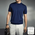 Men's solid colour knitted t-shirt with round neck and short sleeves in a polyester blend fabric.