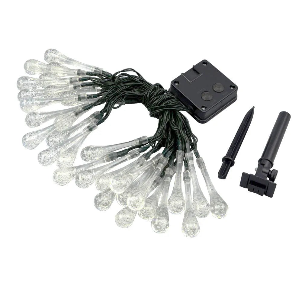 Solar-powered LED outdoor string lights with water drop-shaped pendants in garden setting