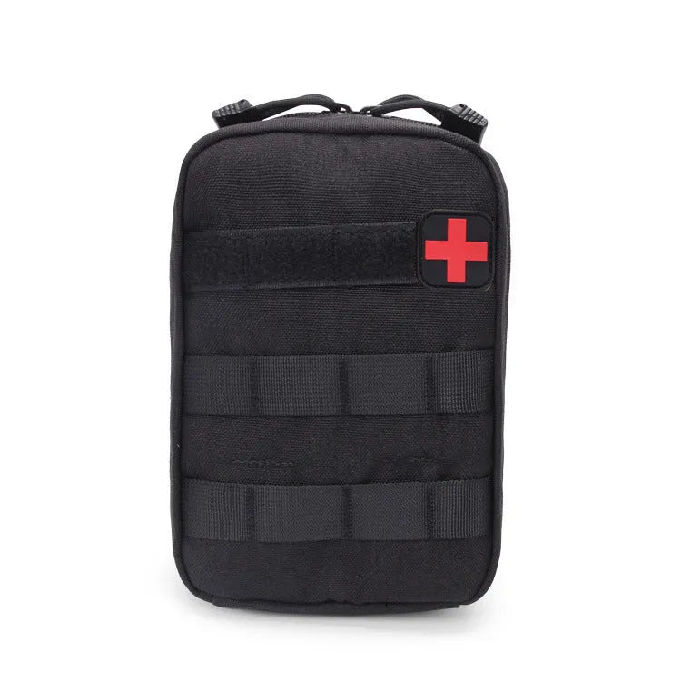 Army green nylon tactical medical accessory pouch with hook-and-loop fastening, shown next to a tape measure.