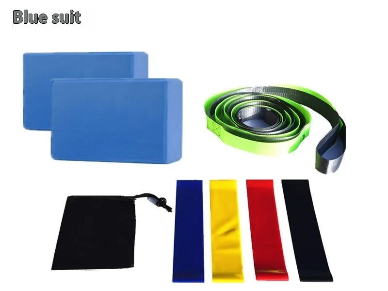 Yoga block eight-piece set with bricks, stretch belt, latex bands, and black storage bag on a floor.