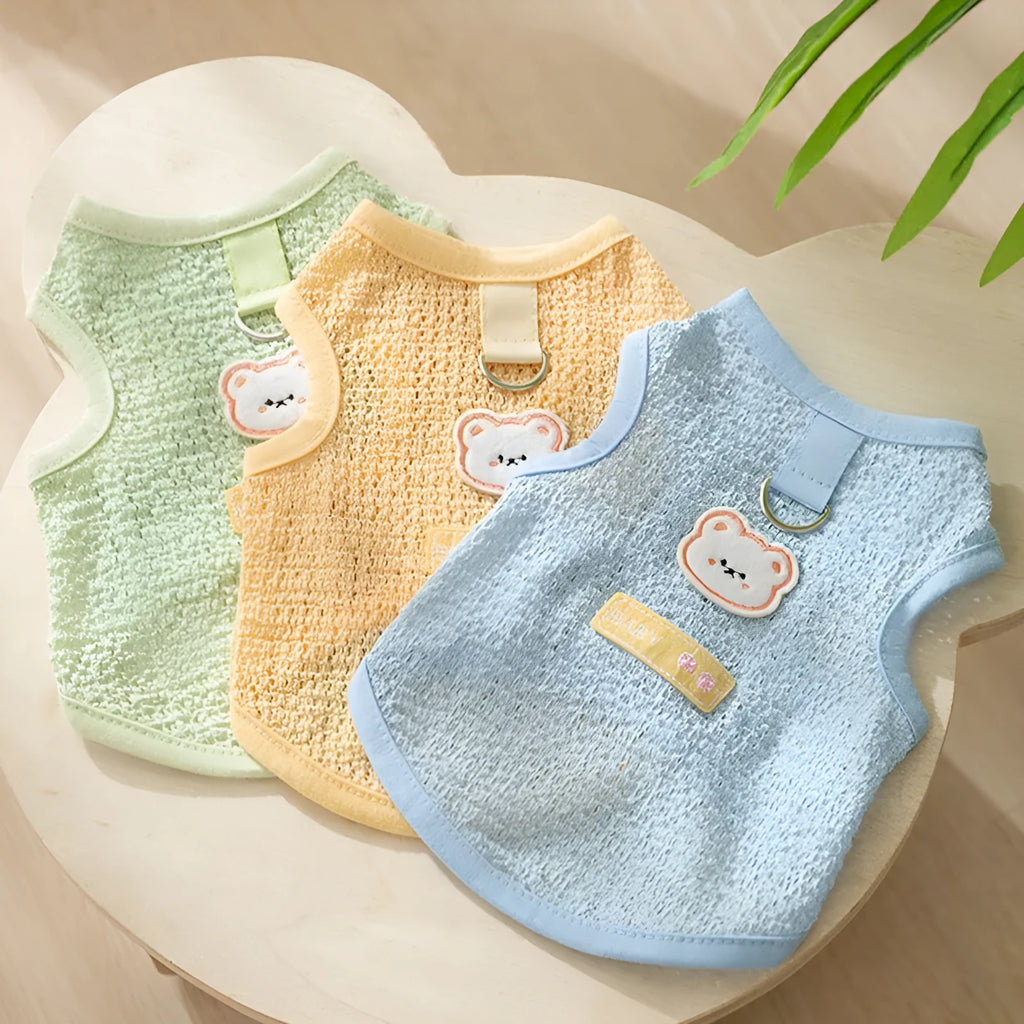 Colourful knitted cat clothes with a bear patch, showing hollowed-out breathable fabric.