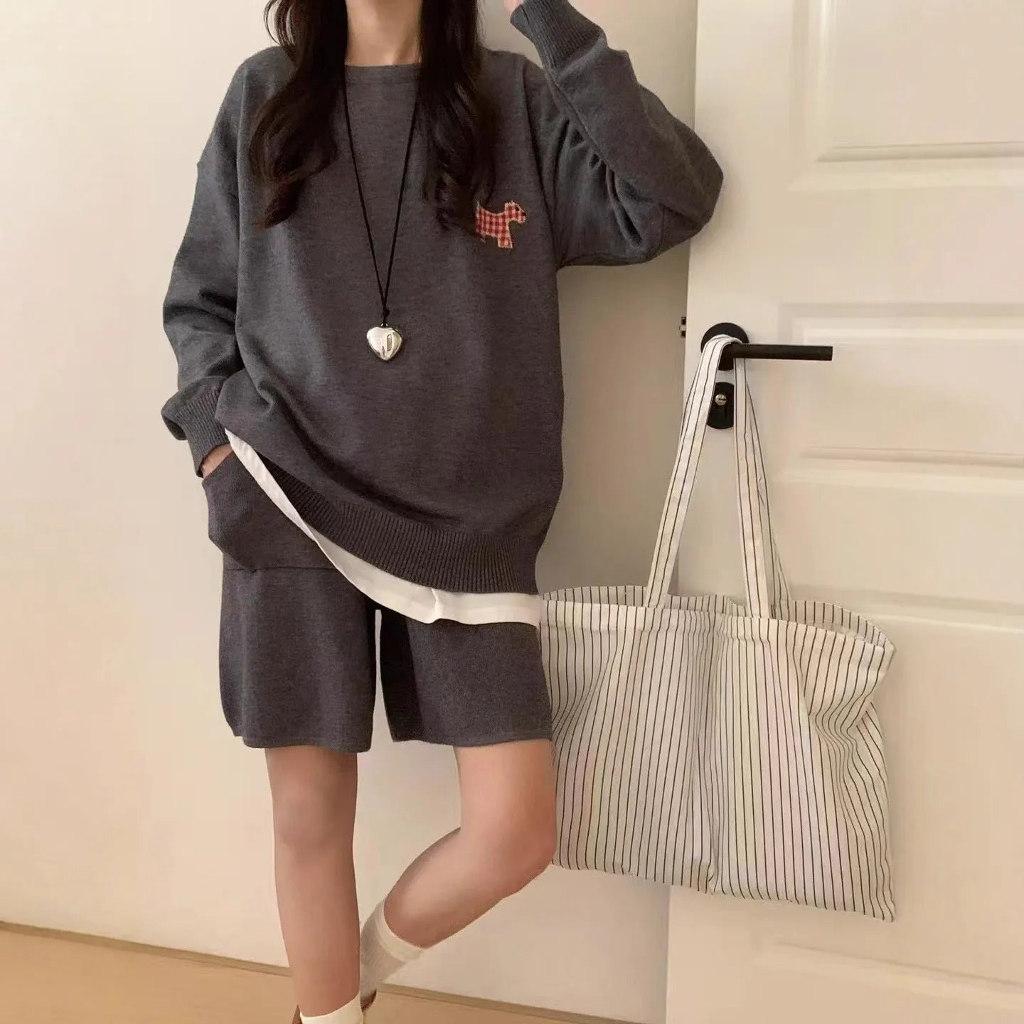 Women's milk blue knitted sweater and shorts set with animal embroidery pattern.