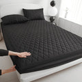 Diamond lattice quilted waterproof mattress protector and pillowcases in a solid colour.