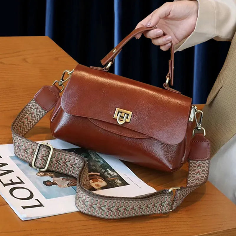 Women's dark brown genuine leather saddle back handbag with multiple compartments and shoulder straps