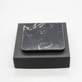 Real marble wireless charger on a desk with indicator light showing blue charging status