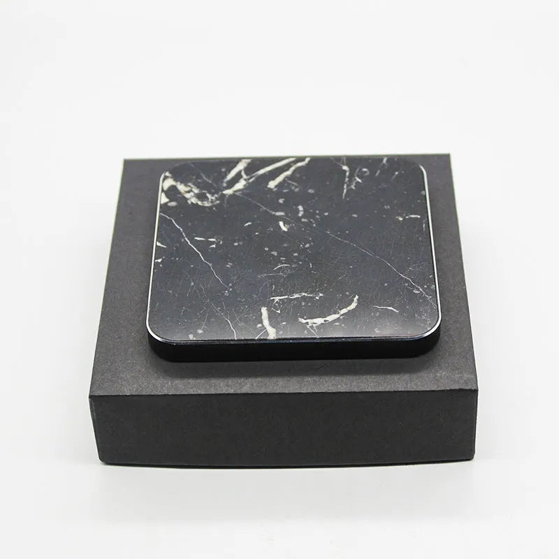 Real marble wireless charger on a desk with indicator light showing blue charging status