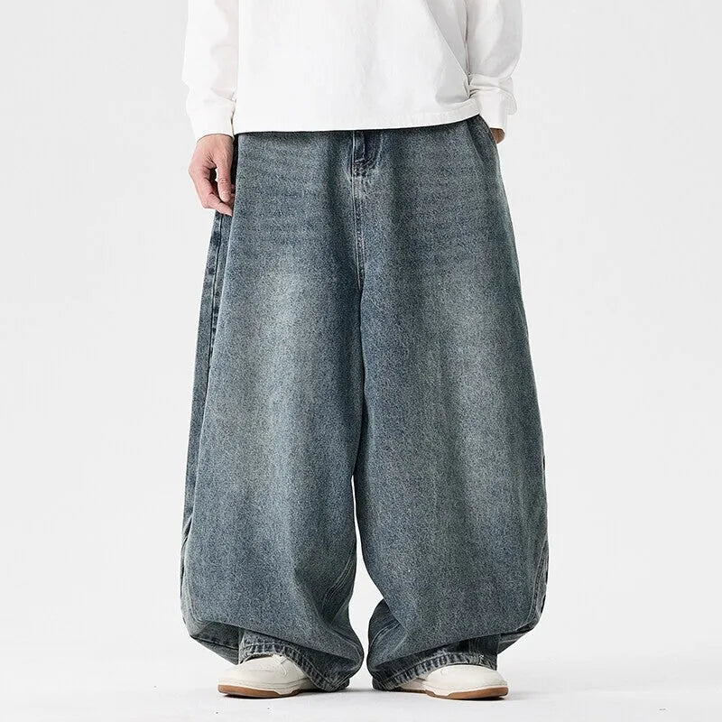Men's plus size baggy jeans in dark blue denim with a straight leg and low waist.