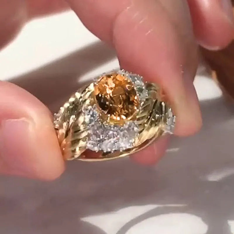 Gold colour copper women's ring with embossed feather pattern and yellow zircon stones on geometric band