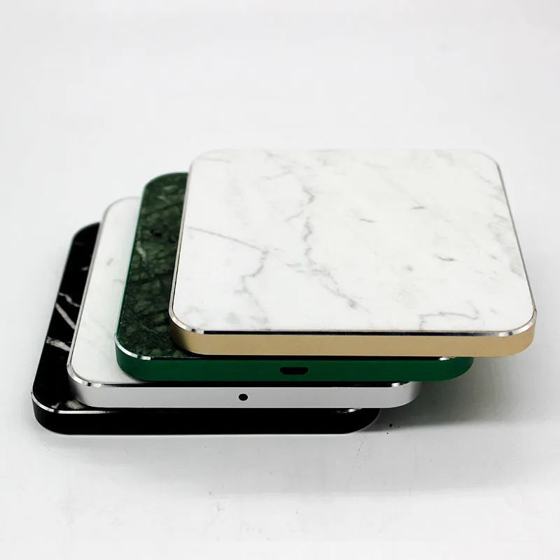 Real marble wireless charger on a desk with indicator light showing blue charging status