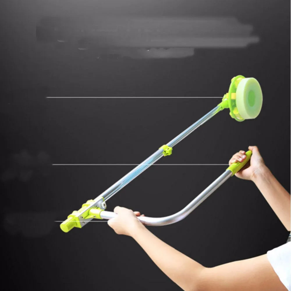 Green telescopic glass wiper with extendable handle resting on a windowsill