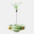 Cat UFO tumbler turntable toy with blue plastic base and feather attachment on a white background, pet entertainment product