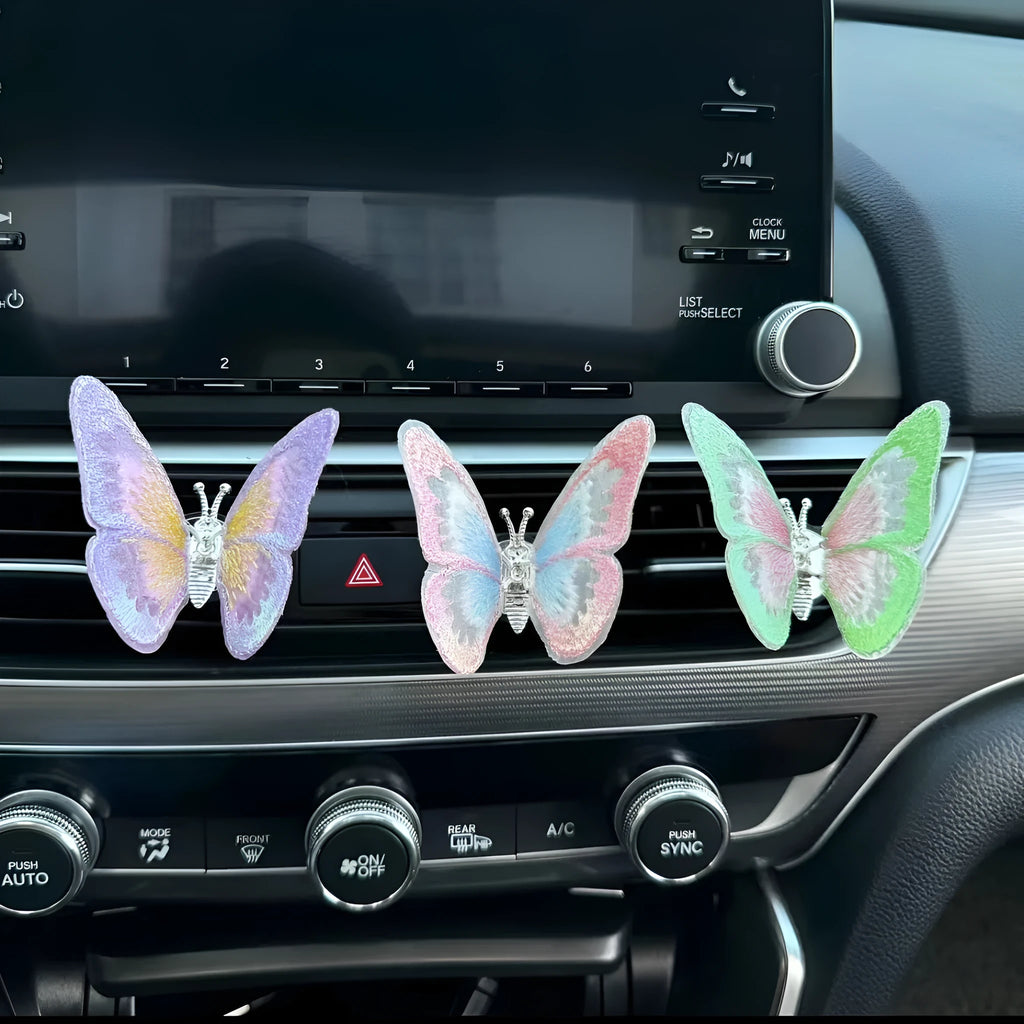 Moving embroidery butterfly decoration on car centre console air vent in pink fabric