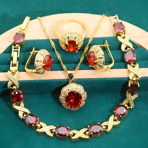 Gold plated jewellery set with blue cubic zirconia stones, showing necklace, earrings, ring, and bracelet.