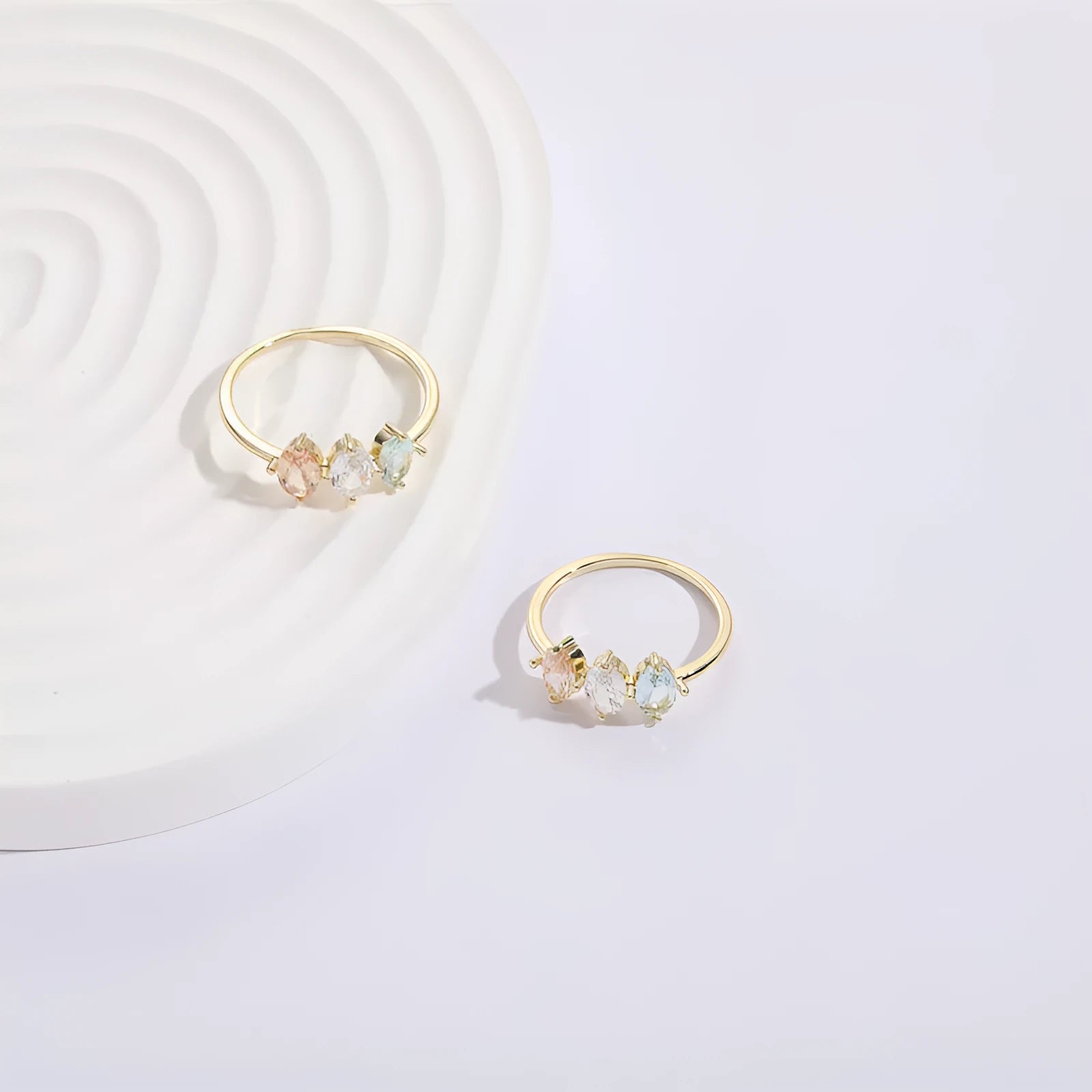 Geometric birthstone ring with horse eye shaped tricolor zircon stones in gold colour