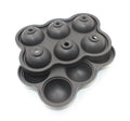 Large black silicone ice cube maker with six 4.5cm sphere cavities on a white background
