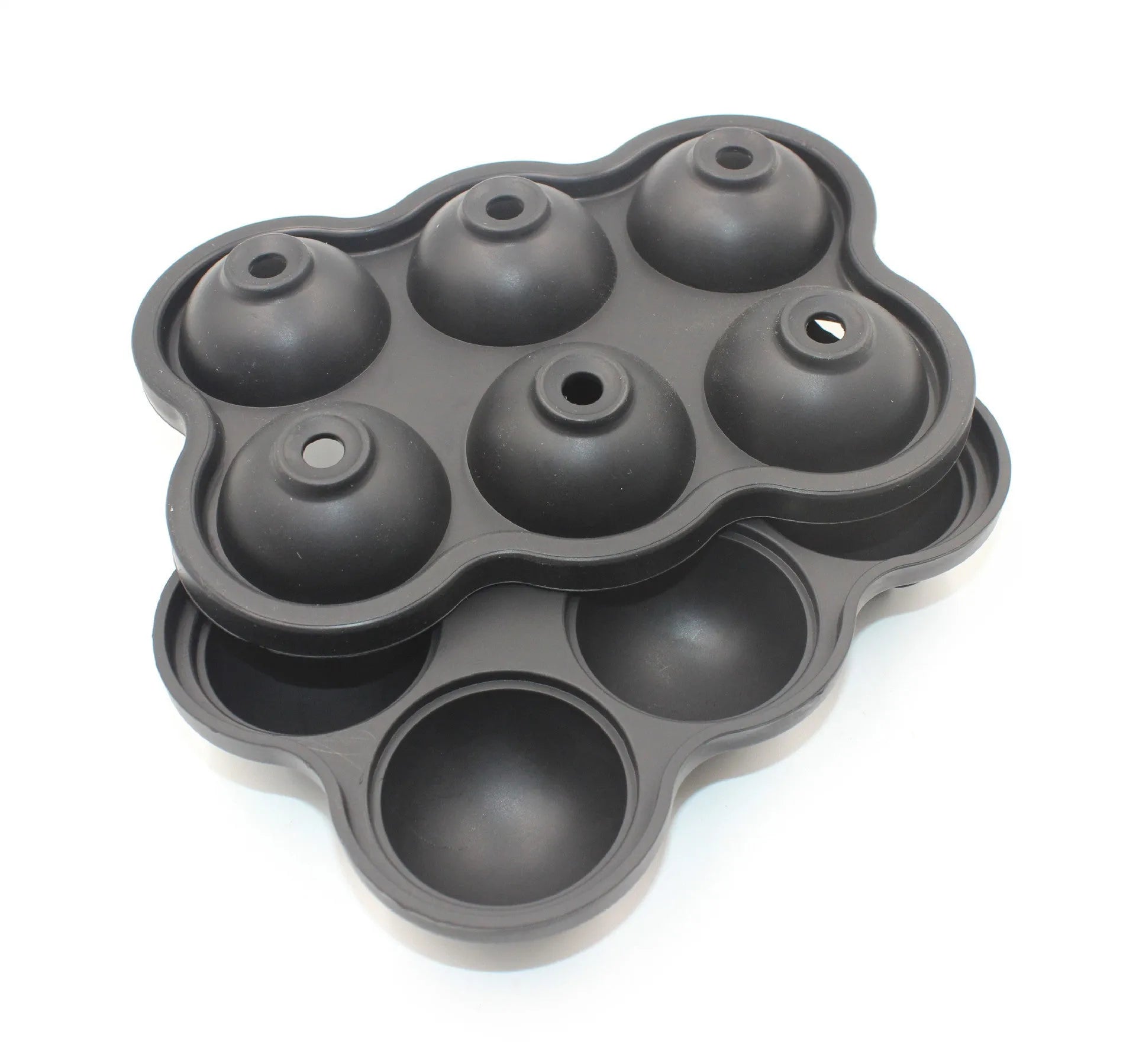 Large black silicone ice cube maker with six 4.5cm sphere cavities on a white background
