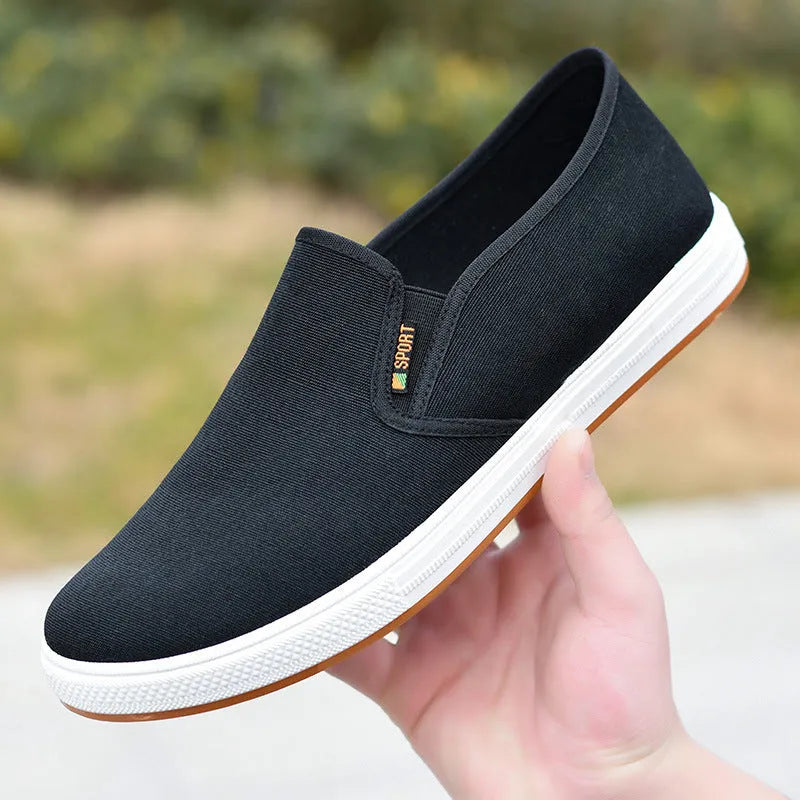 Men's black and blue canvas slip-on shoes with low-top design and round toe