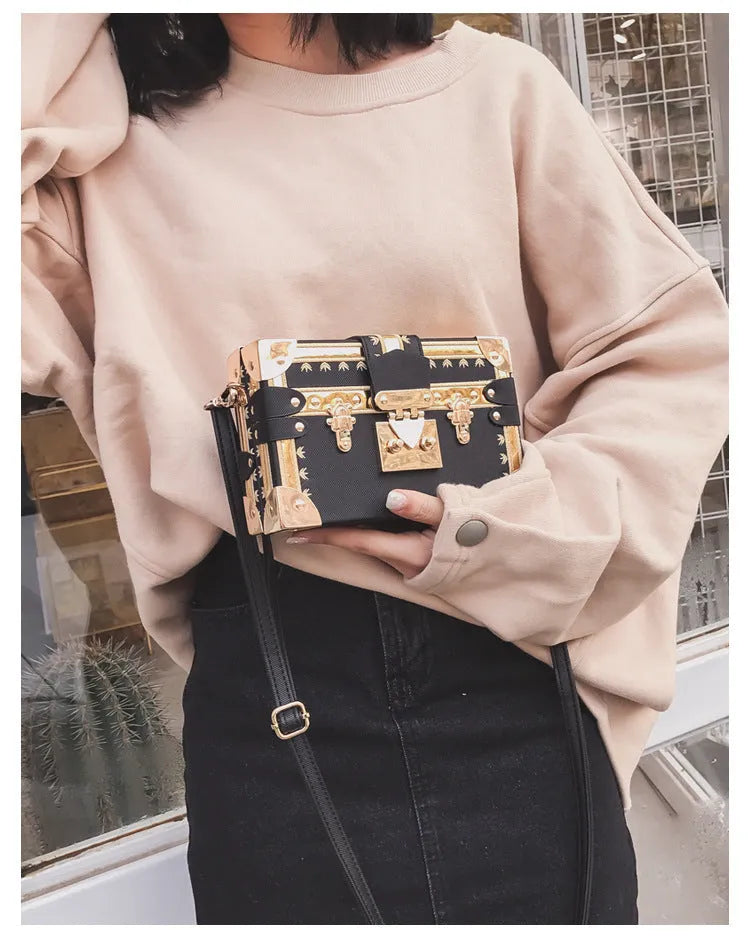 Women's hard PU shoulder bag with flap closure and crossbody strap in black colour with rivet decoration