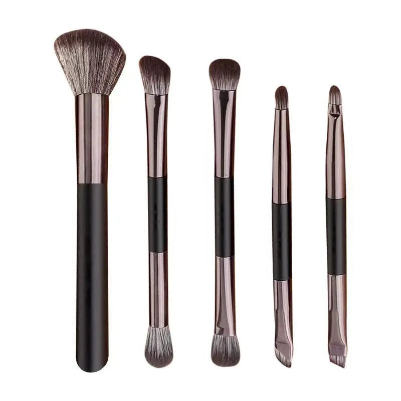 Makeup brush set in case with mirror showing 4 or 5 artificial fibre brushes in silver, gold or sparrow design