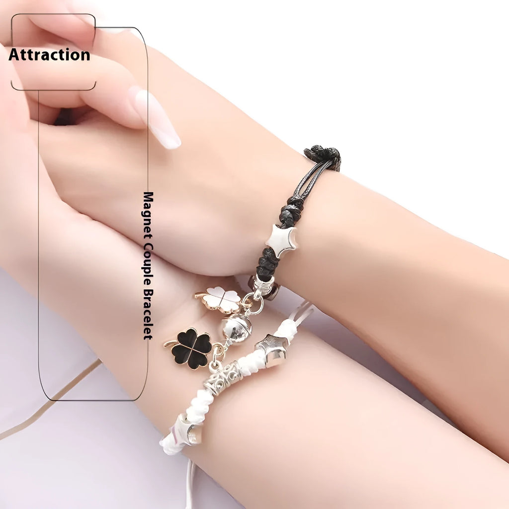Pair of magnetic suction bracelets with alloy charms in various love and friendship themed designs on a wrist.