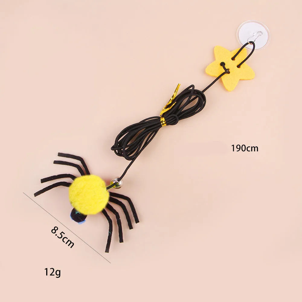 Hanging door cat toy with elastic rope, feather, bell, and spider attachment in red colour