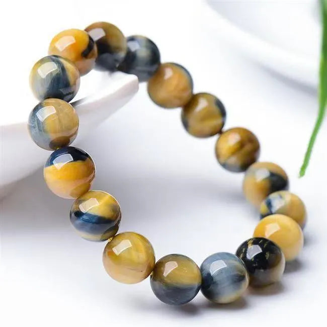 Fantasy Tigereye agate beaded bracelet with round geometric beads on a wrist, showing natural stone colour.