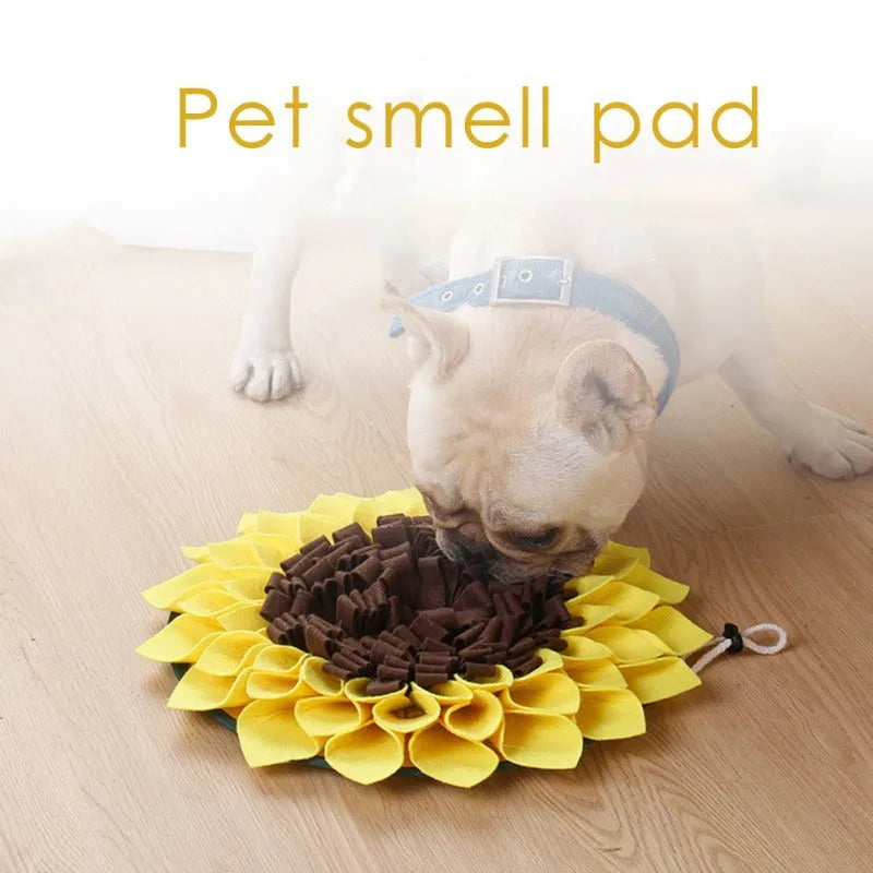 Yellow sunflower-shaped dog snuffle mat with fleece texture and a hanging rope buckle.