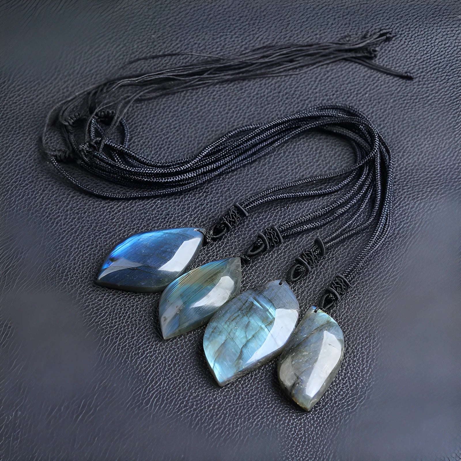 Natural labradorite leaf pendant necklace with blue moonlight effect on white background